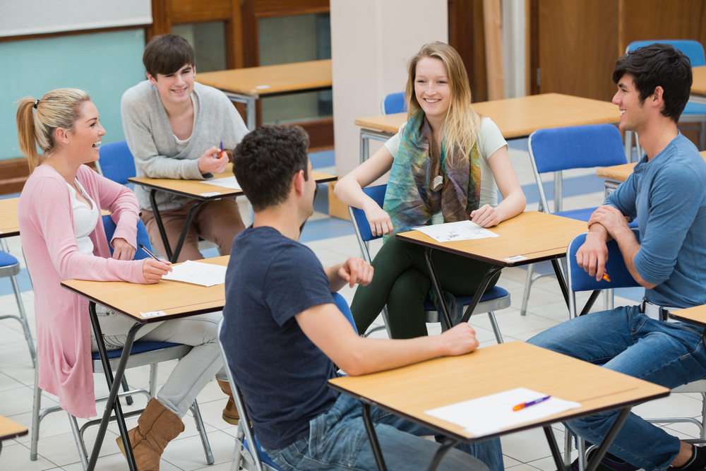 Students sitting in a classroom and talking while having fun