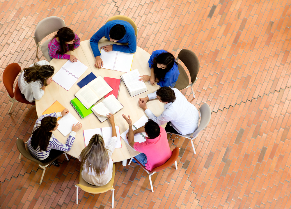 Study group with young people sitting in a round table