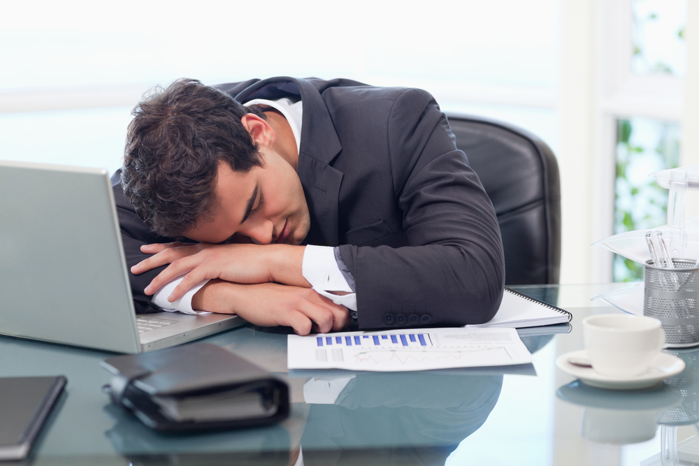 Tired businessman sleeping in his office